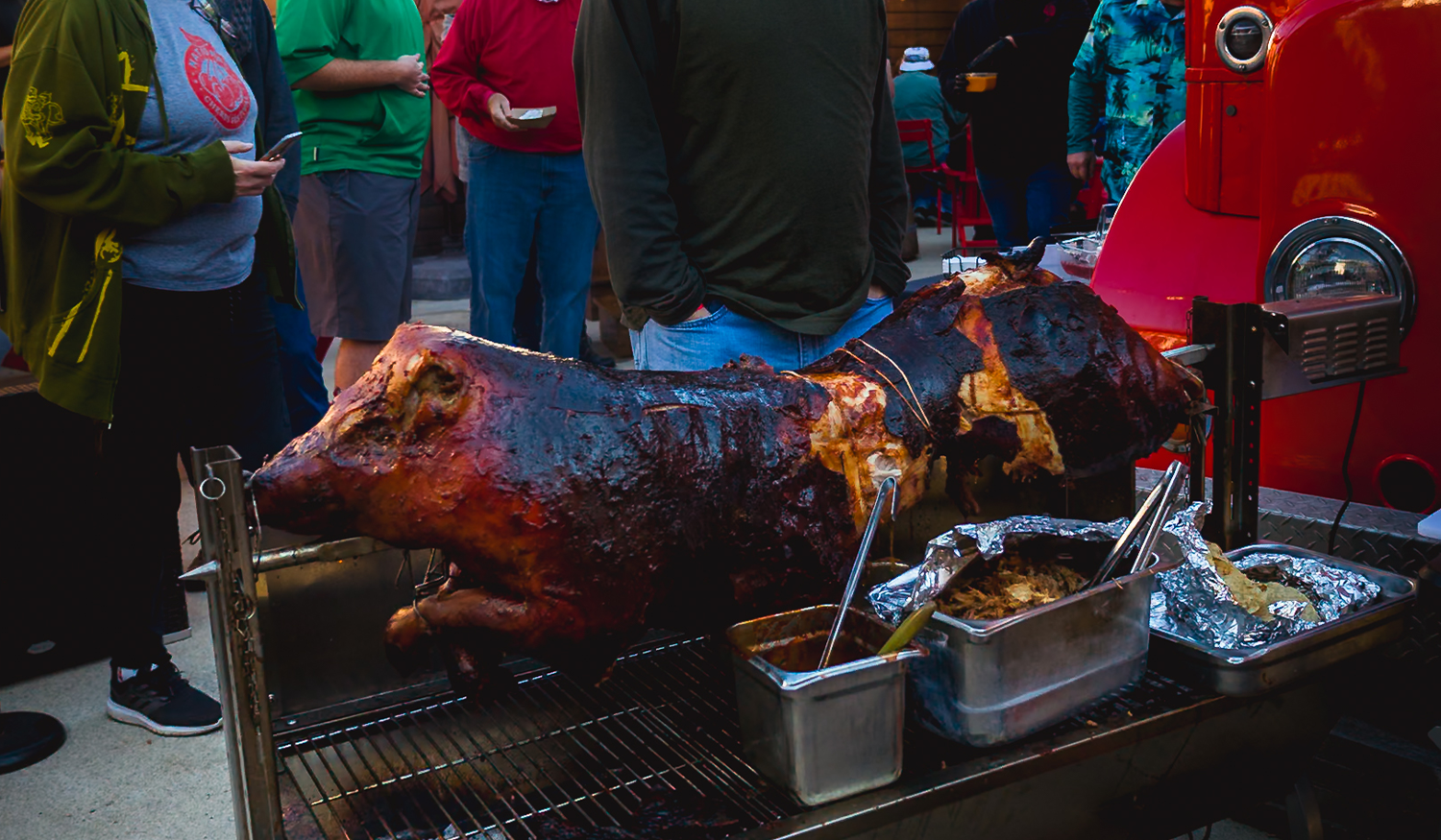 Whole pig roasting on a spit at Porktoberfest